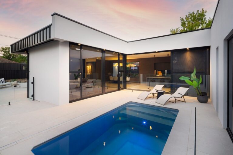 Black aluminium glazing around the pool courtyard at Downer Residence