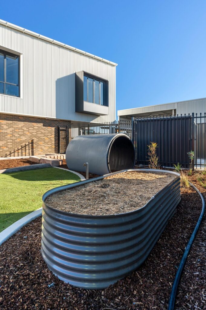 Corner glazing and dark aluminium frames at Margaret Hendry School