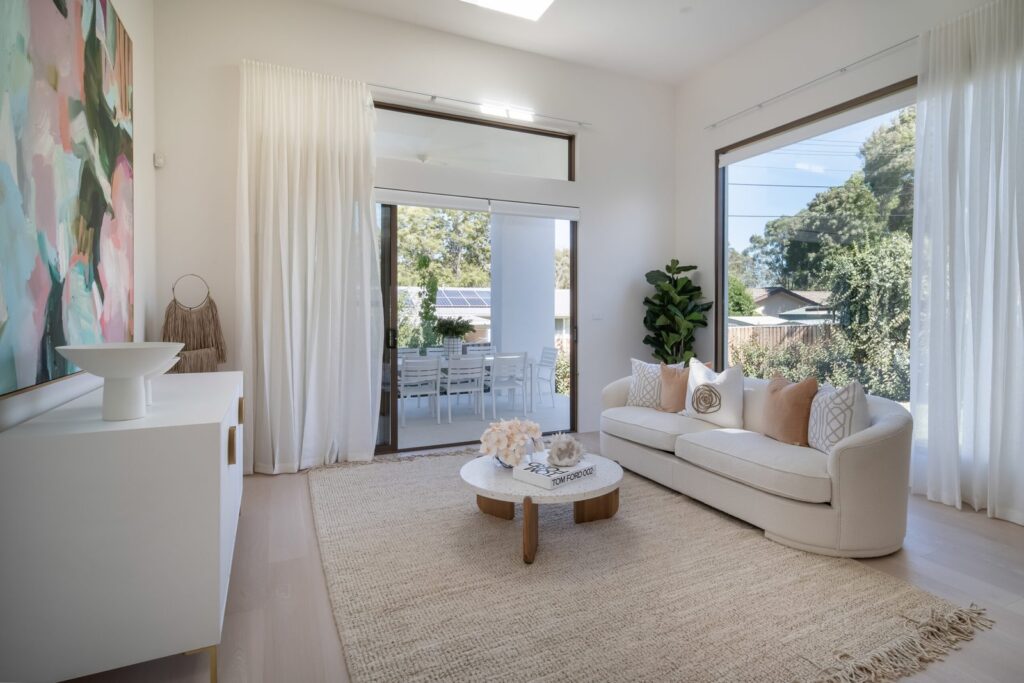 Large windows and glazed terrace door in the living room at the Curtin Duplex