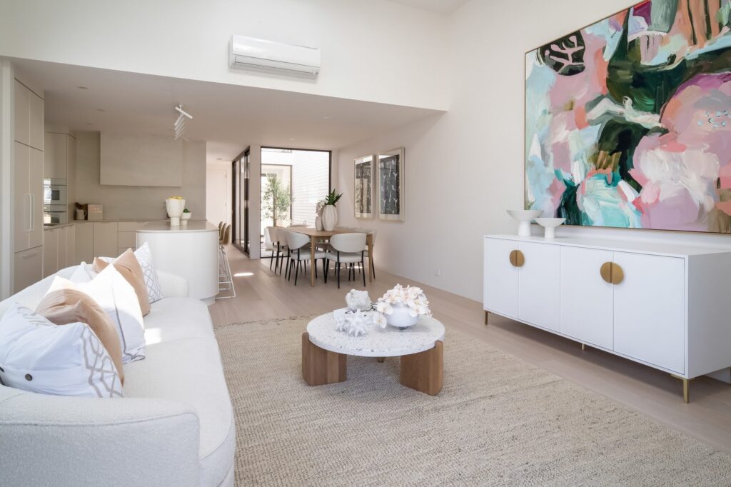 Open-plan living and dining spaces with courtyard glazing at the Curtin Duplex