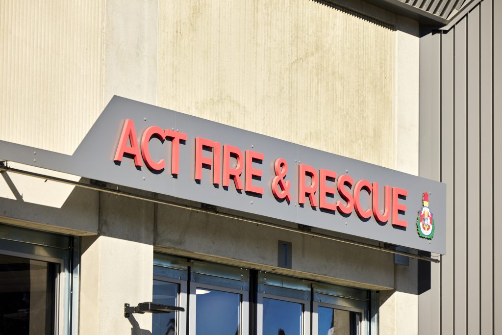 ACT Fire & Rescue signage above glazing and horizontal shading at Acton Station